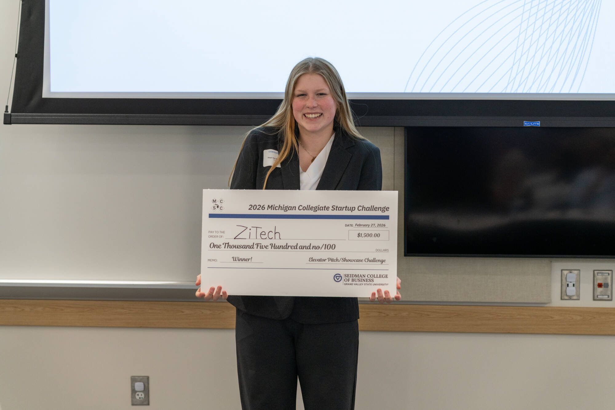 Representative of ZiTech with their prize check